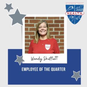 Image: Silver and blue box w photo of employee of the quarter and their name; silver stars; health department logo